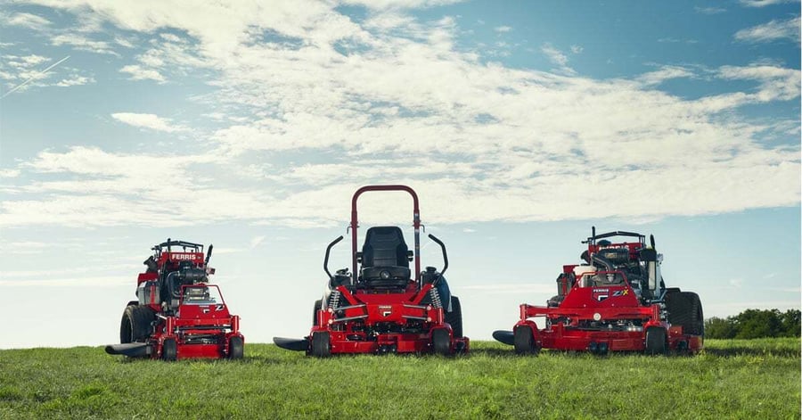 A Ferris mower working an open property in early morning light